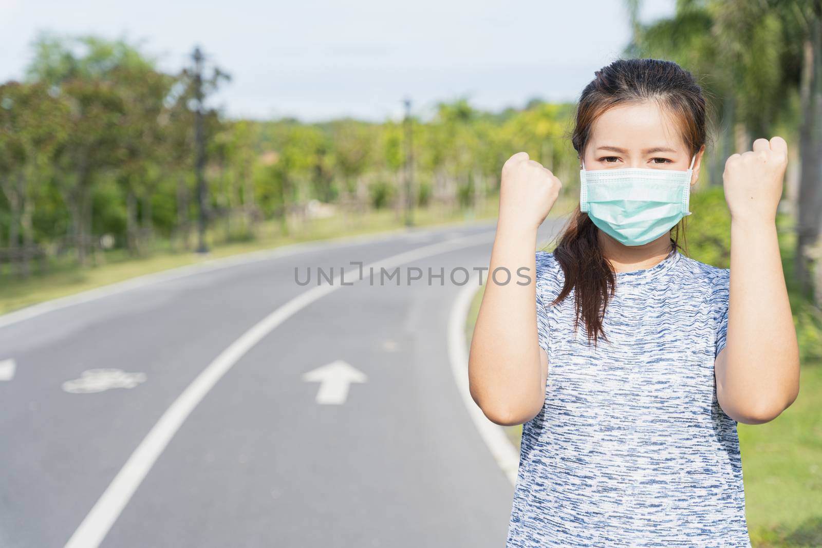 Young female wearing medical mask and show her hand to fight the by mikesaran