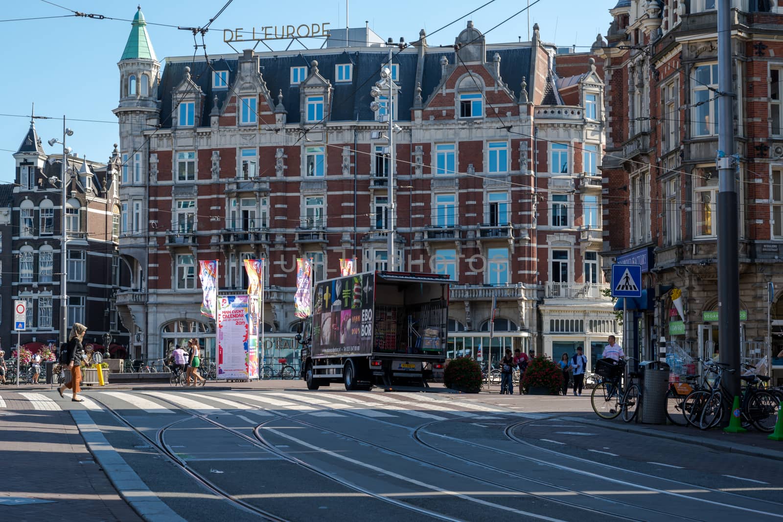 Amsterdam, the Netherlands — July 30, 2019. Photo of a busy intersection in the center of Amsterdam on a late summer morning.