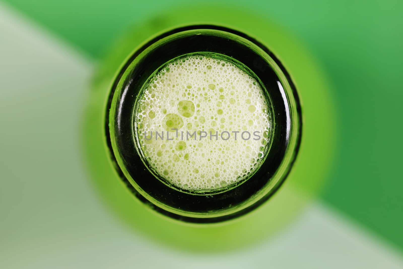 Beautiful  green bottle rim with white bubbles on green background