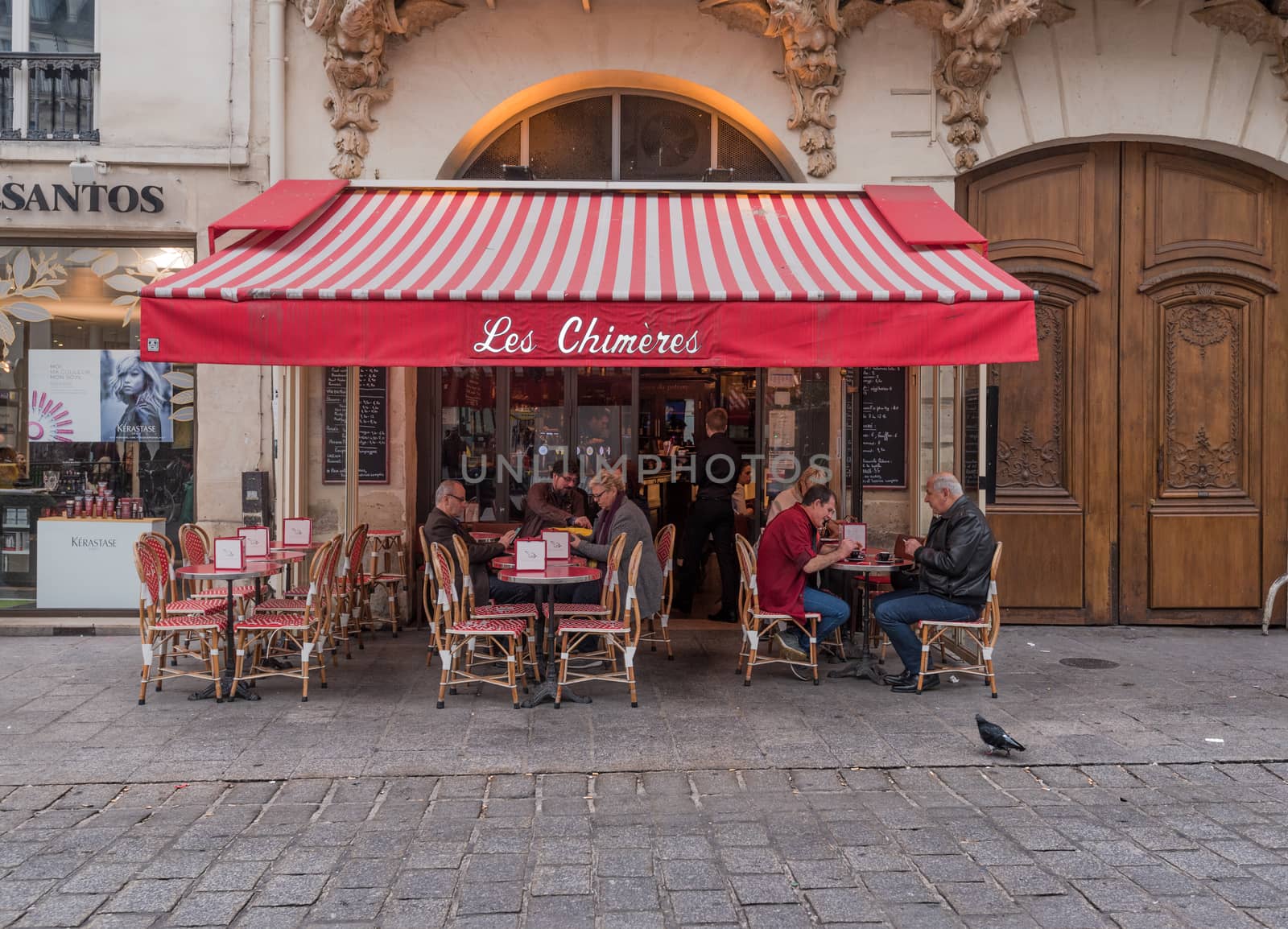 Paris, France -- November 4, 2017--People are enjoying coffee and snacks outdoors in a Parisian cafe.