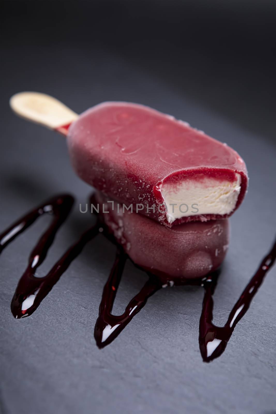 Fruit ice cream stick looks fresh to eat placed on a black background.