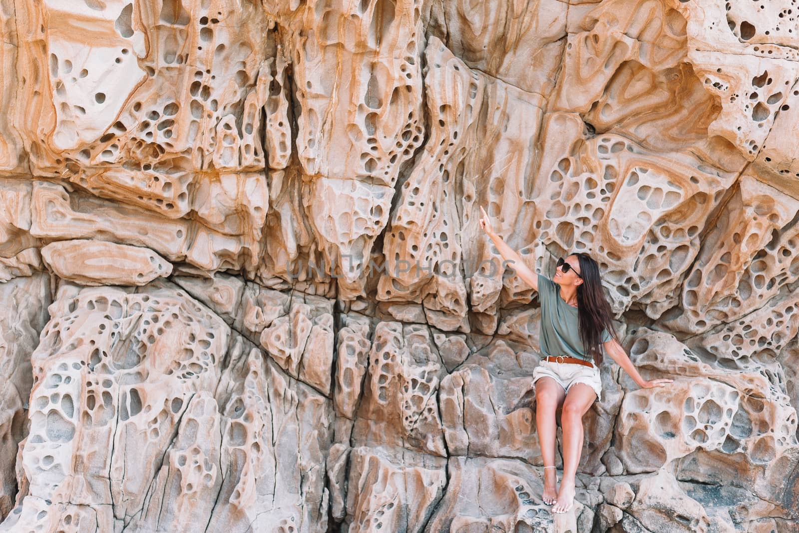 Cheese rocks from quartzite sandstone on Balck Sea in Crimea. Tourist girl in mountains by travnikovstudio