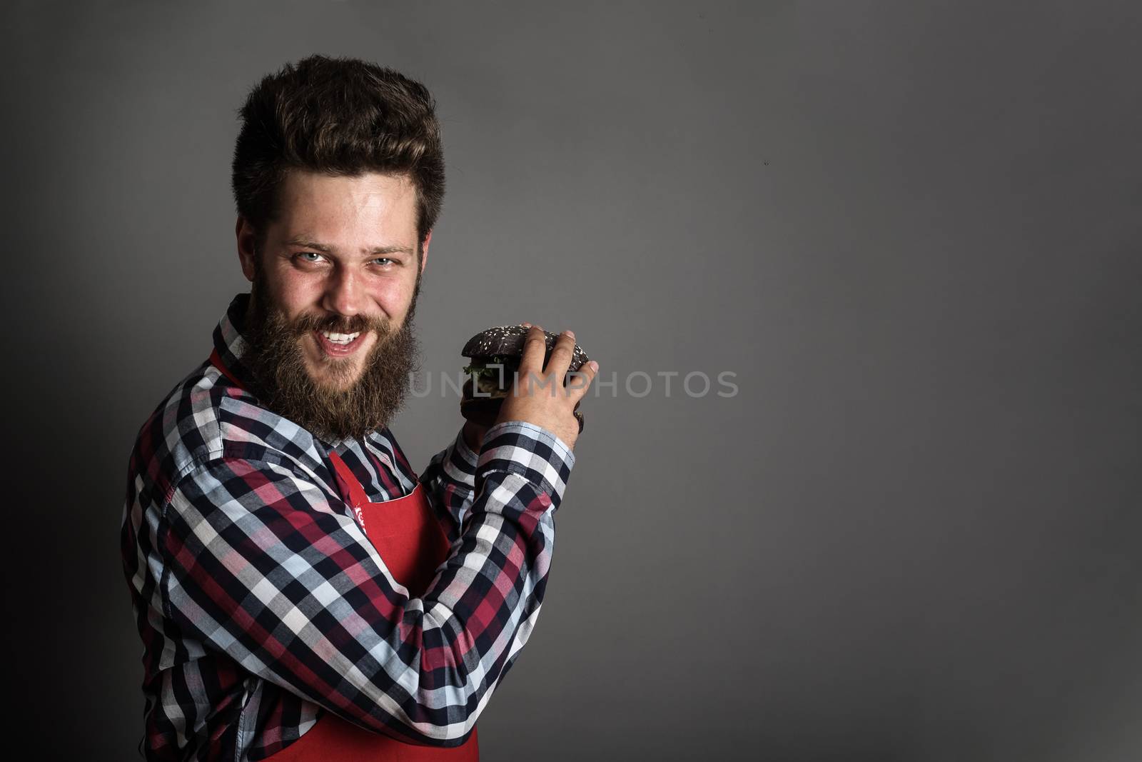 Greedy man with a hamburger in his hands fast food diet eating copy space for text background