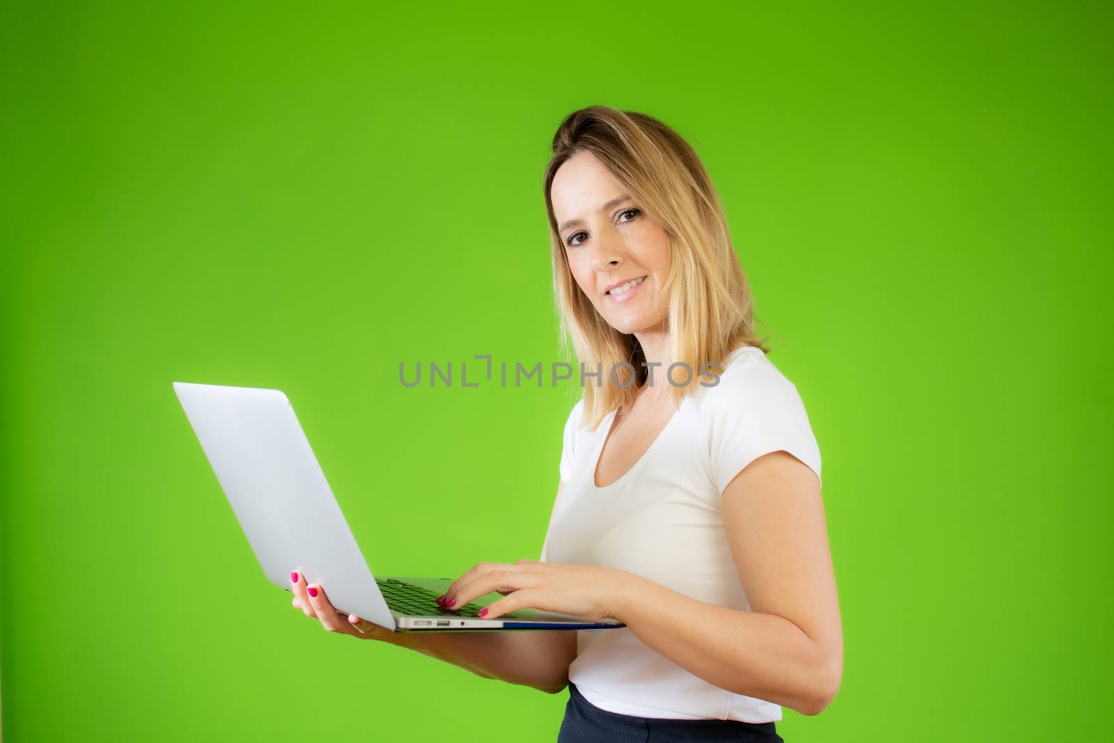Pretty young woman in white shirt using a computer