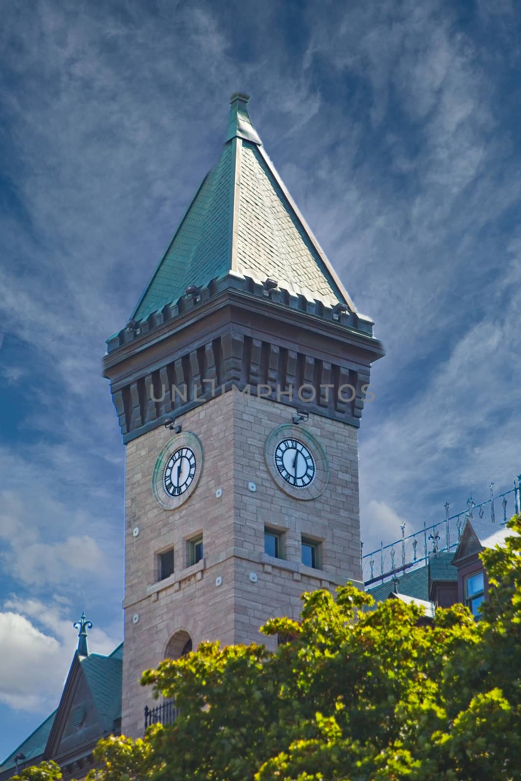 Clock Tower on Stone Building with Green Roof by dbvirago
