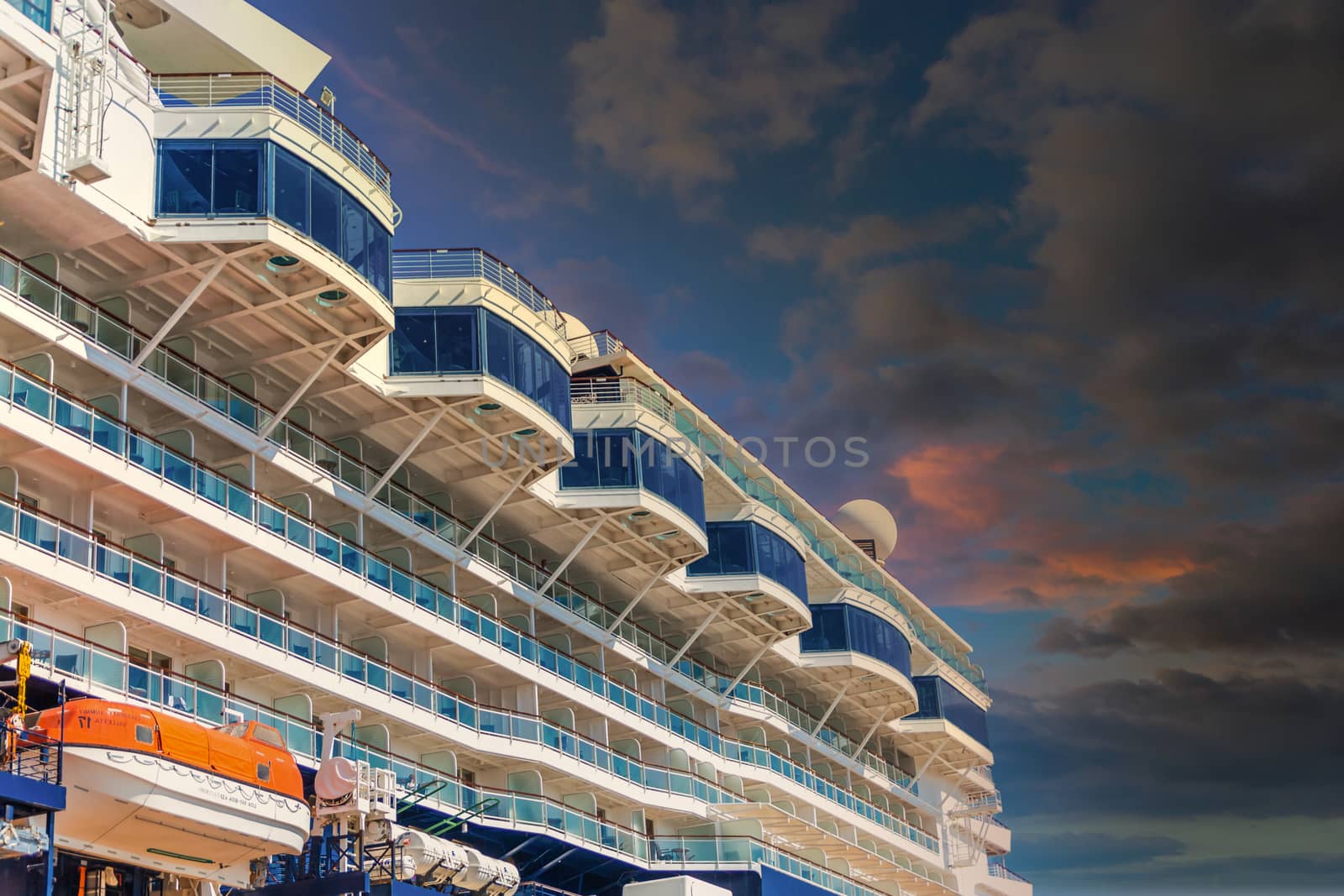 Upper windows of a luxury cruise ship against blue sky