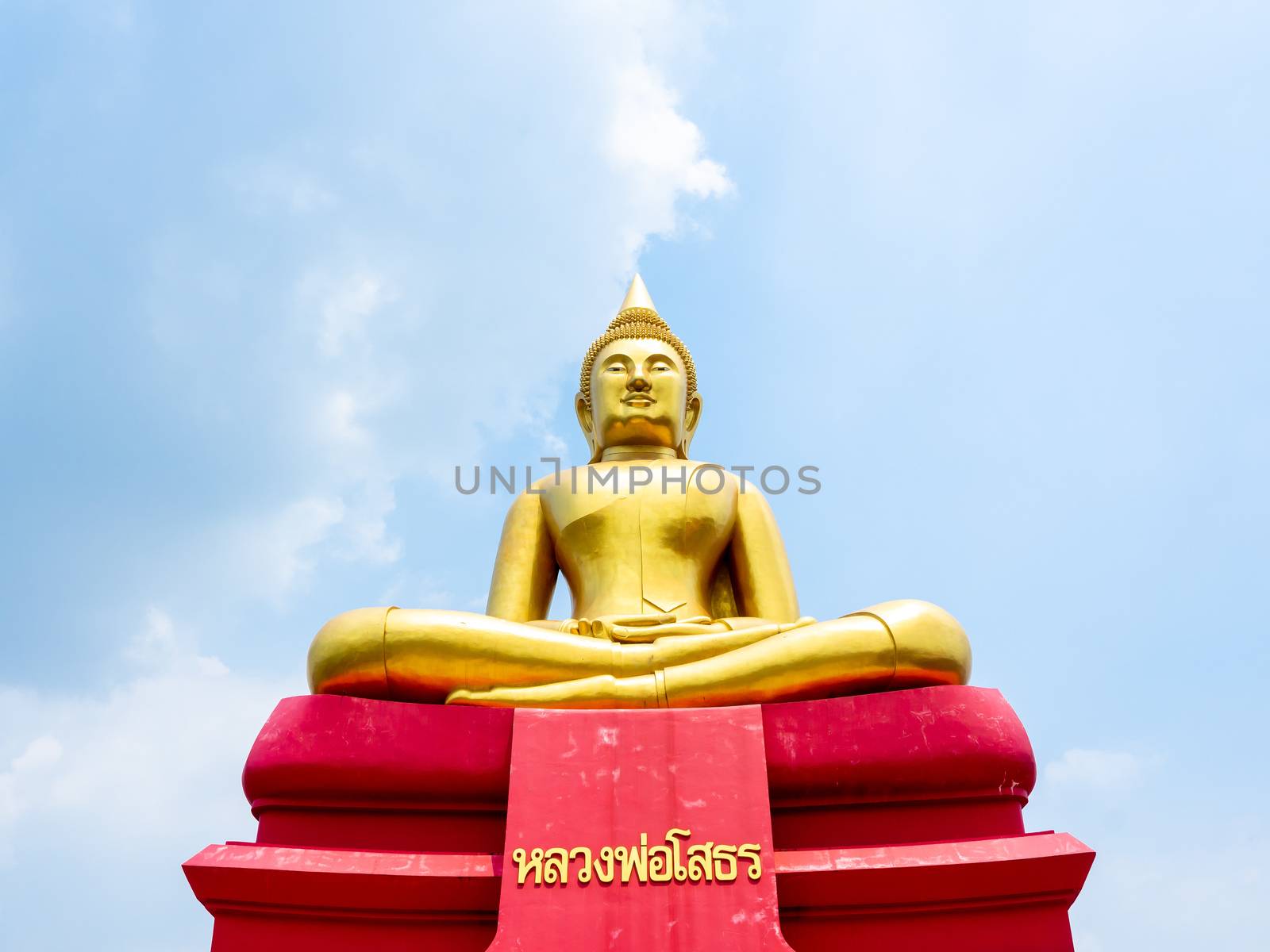 PATHUM THANI, THAILAND - May 2 : 2020. Beautiful big buddha with Thai languash name "Luang Phor Sothorn" on blue sky background at Wat Bot Temple at Pathum Thani, THAILAND.