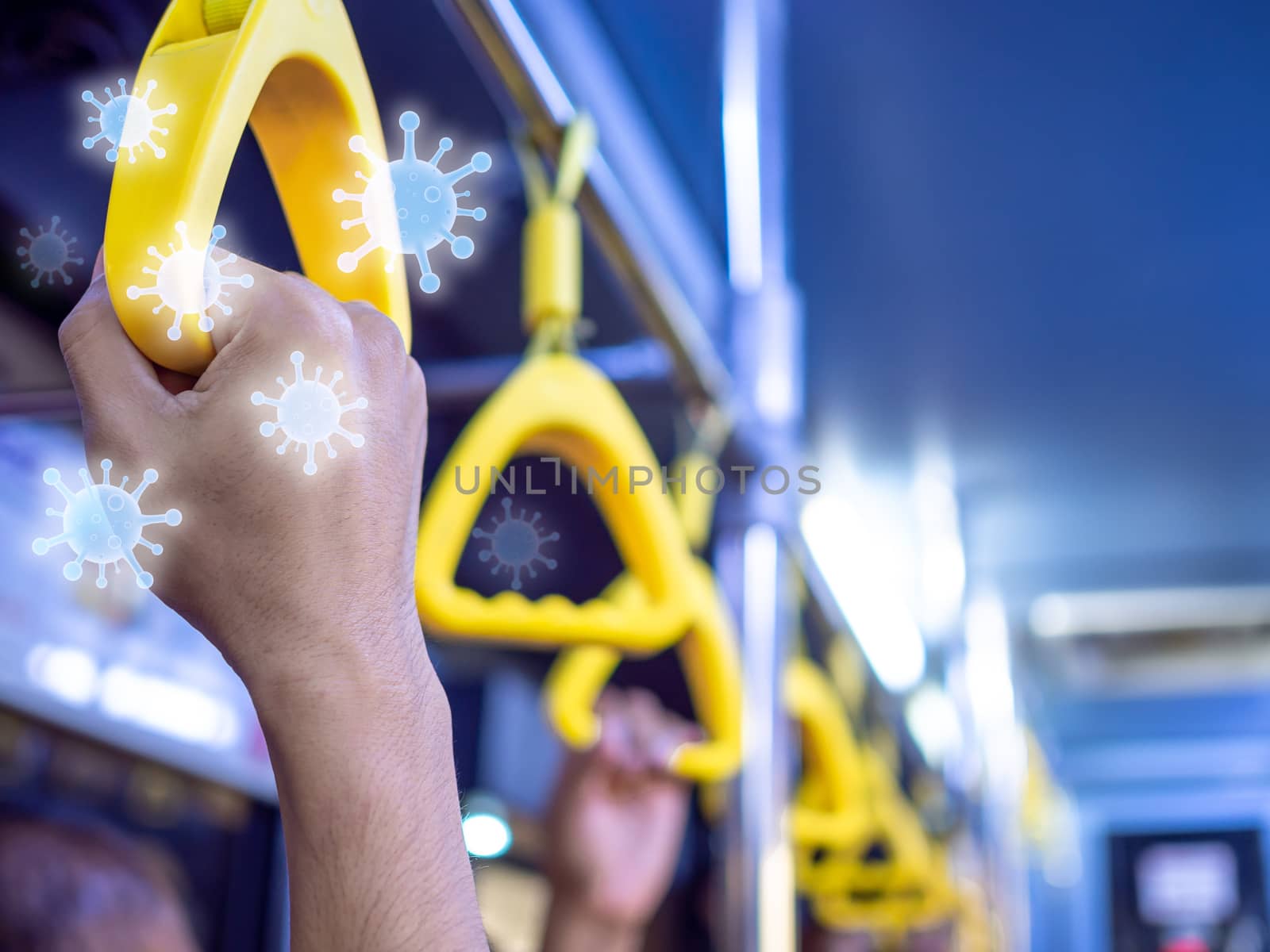 Close-up hand holding yellow handle in the shuttle bus with virus floating around. Virus infection spread disease concept.