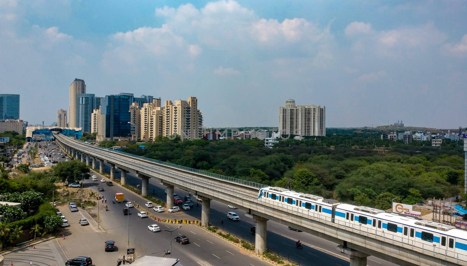 Gurgaon, India, 2020. Aerial shot of Rapid metro tracks in urban areas of Delhi NCR, Gurgaon, Noida with metro running on the tracks. A very useful addition to existing DMRC rail network