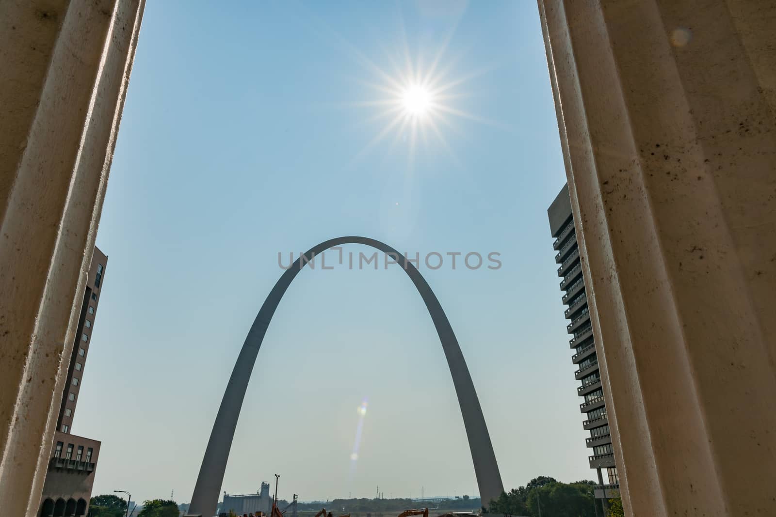 St Louis Gateway Arch at end of city street framed by high-rise buildings. St Louis, architecture, and famous arch, Missouri,USA.