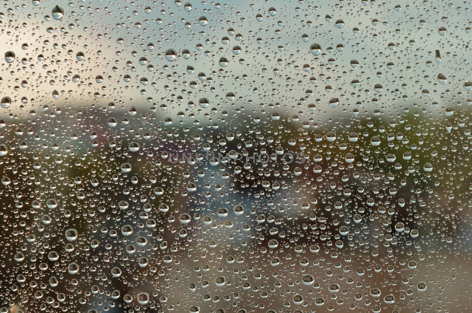 Drops of rain on the window, rainy day. Shallow DOF