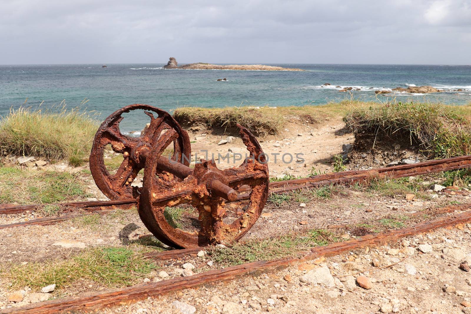 Remains after of granite mining on island Ile Grande in Pleumeur-Bodou in Brittany, France - rails and rusty wheels