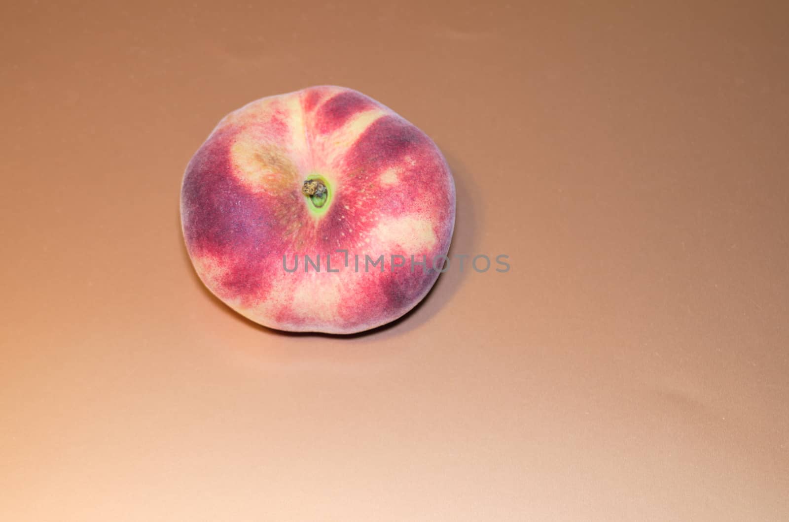 peach - exotic fruit nectarine on a light copper warm background