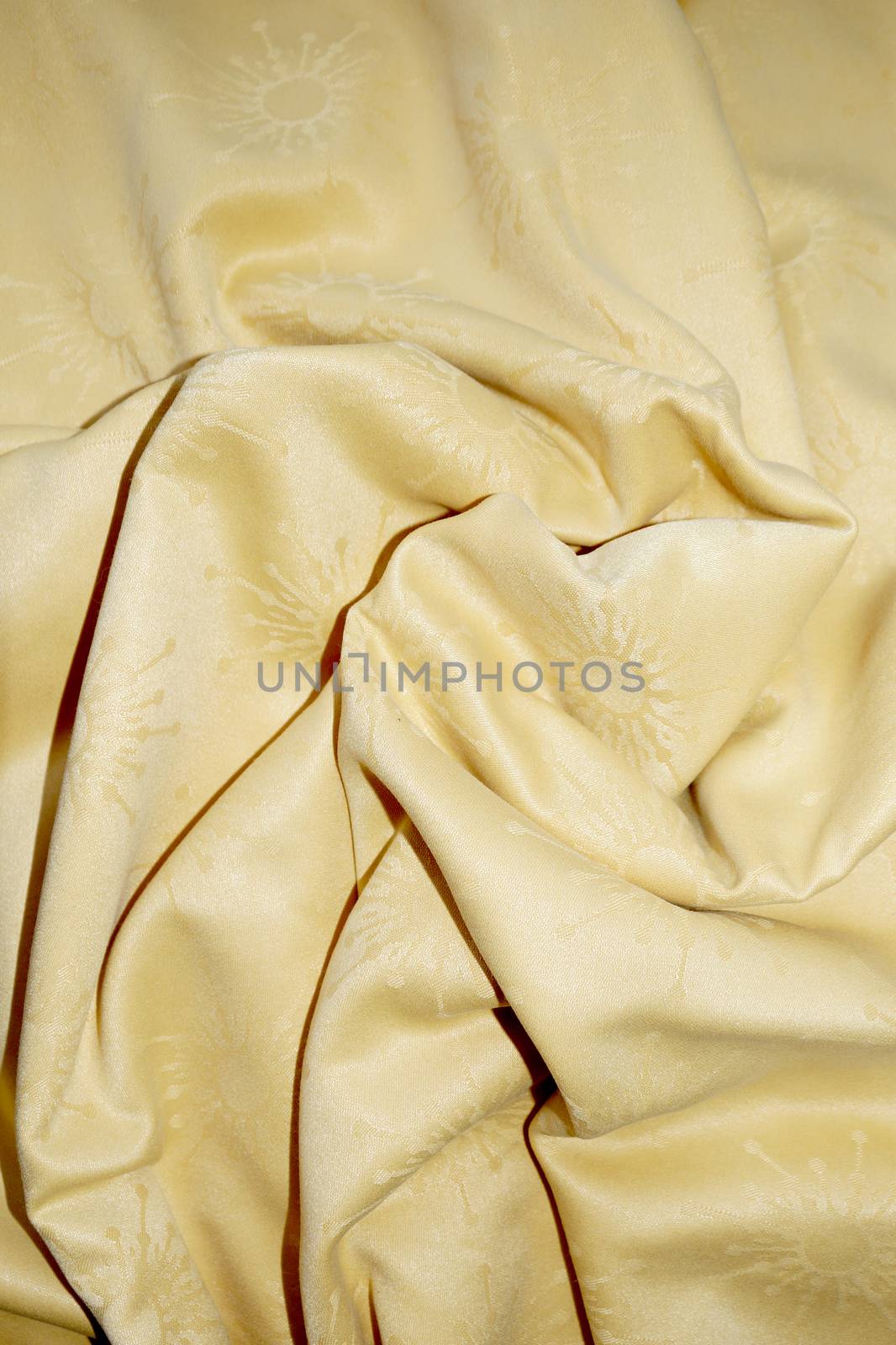 crumpled yellow fabric for background close up