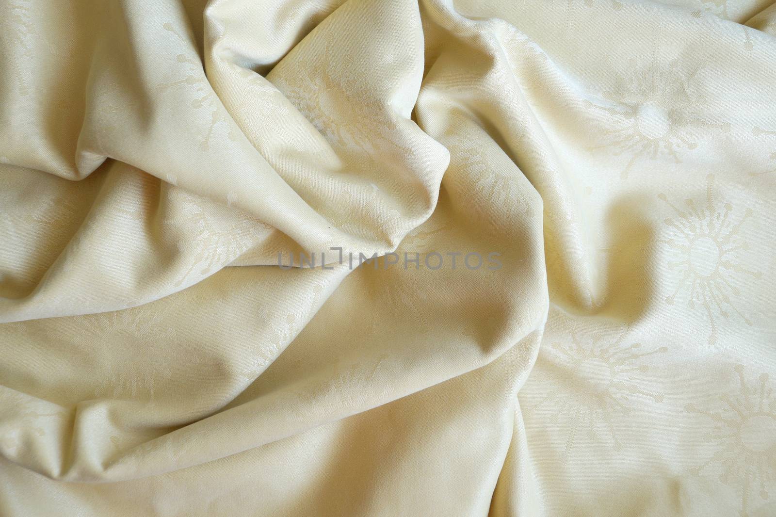 texture of beige textile material in a fold for background close up