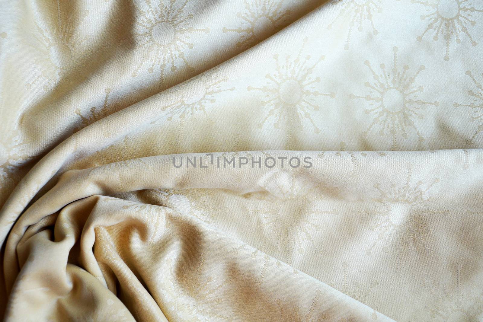 texture of beige textile material in a fold for background close up