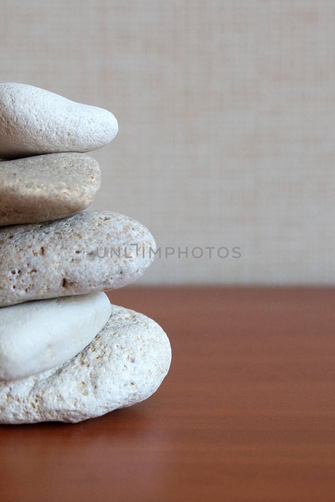 pyramid of round natural stones on a wooden background as a symbol of harmony and balance