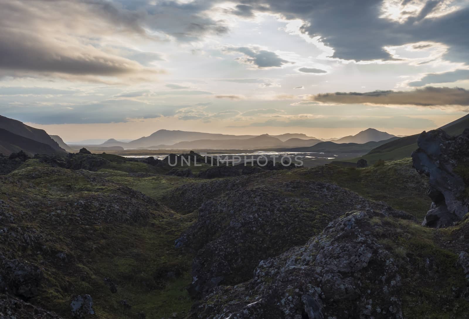 Lava field landscape in Landmannalaugar with river delta and Rhyolit mountain at Sunrise in Fjallabak Nature Reserve, Highlands Iceland.