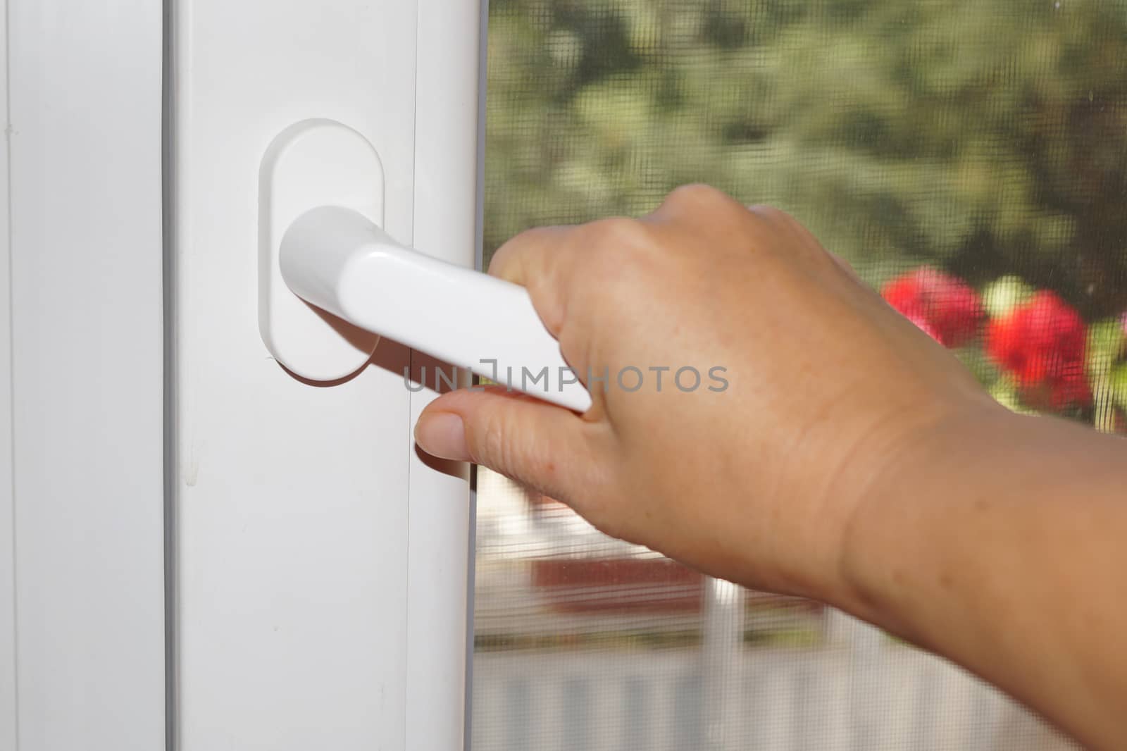 hand opening a plastic window close-up