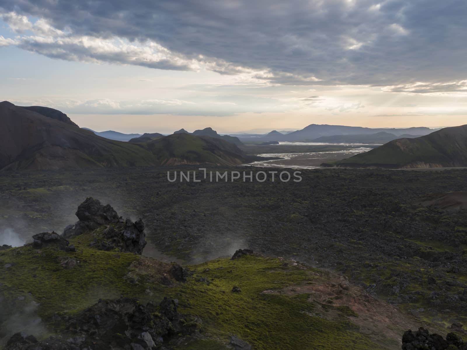 Lava field landscape in Landmannalaugar with and geothermal fumarole, river delta and Rhyolit mountain at Sunrise in Fjallabak Nature Reserve, Highlands Iceland.