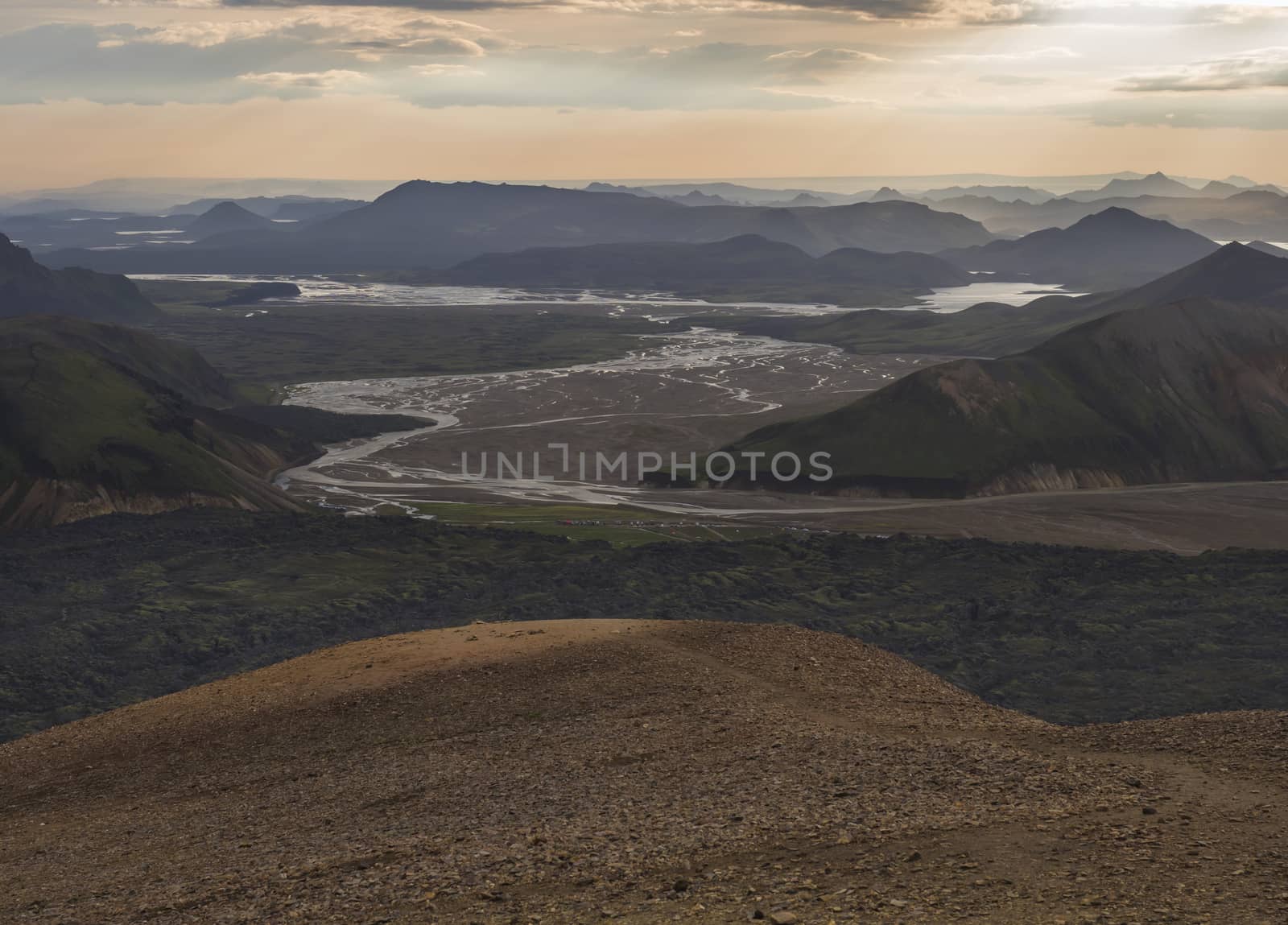 Colorful Rhyolit mountain panorma with view on Landmannalaugar campsite at river delta. Sunrise in Fjallabak Nature Reserve, Highlands Iceland.