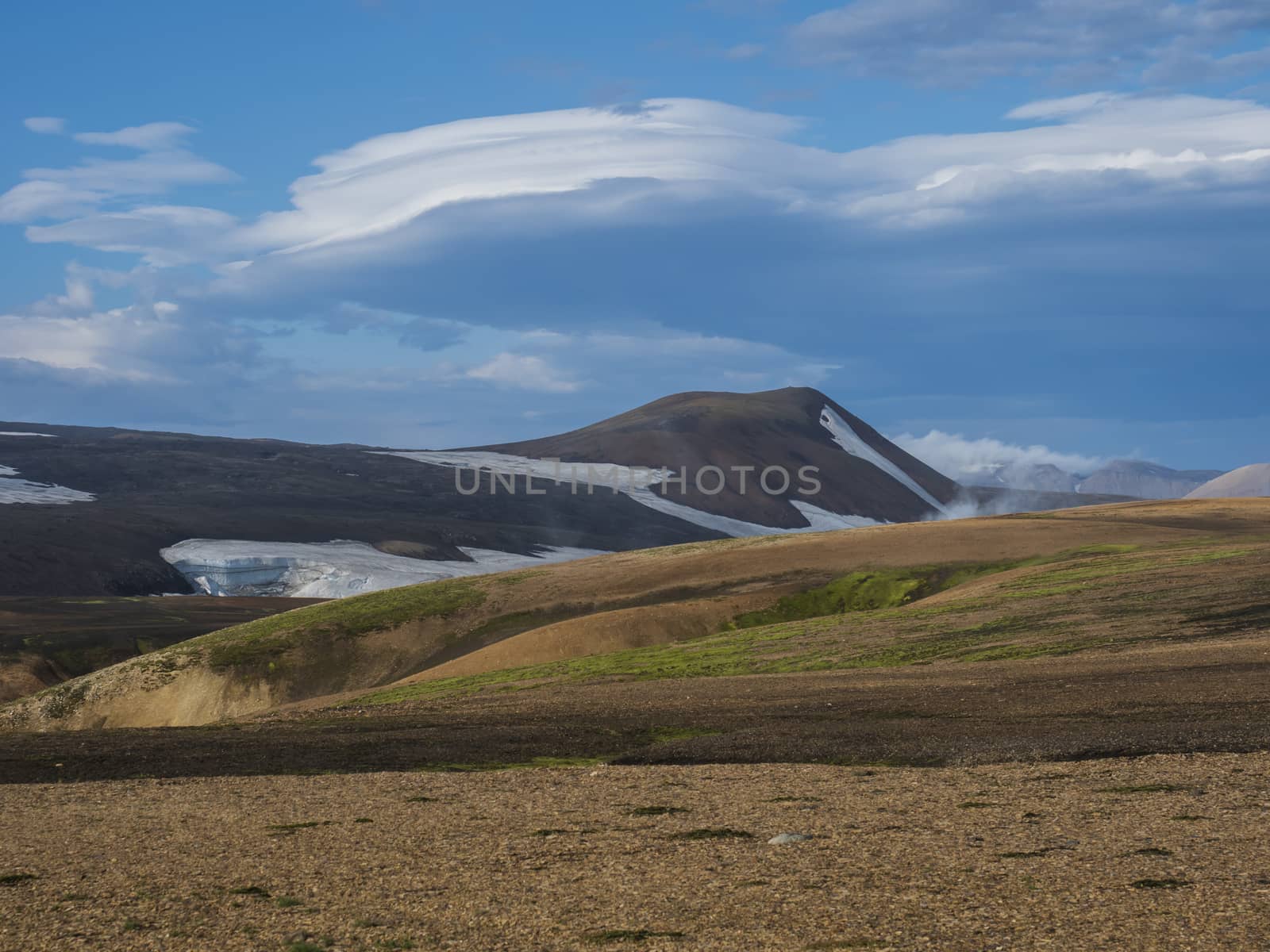 Colorful Rhyolit mountain panorma with snow fiields and multicolored volcanos in Landmannalaugar area of Fjallabak Nature Reserve in Highlands region of Iceland.