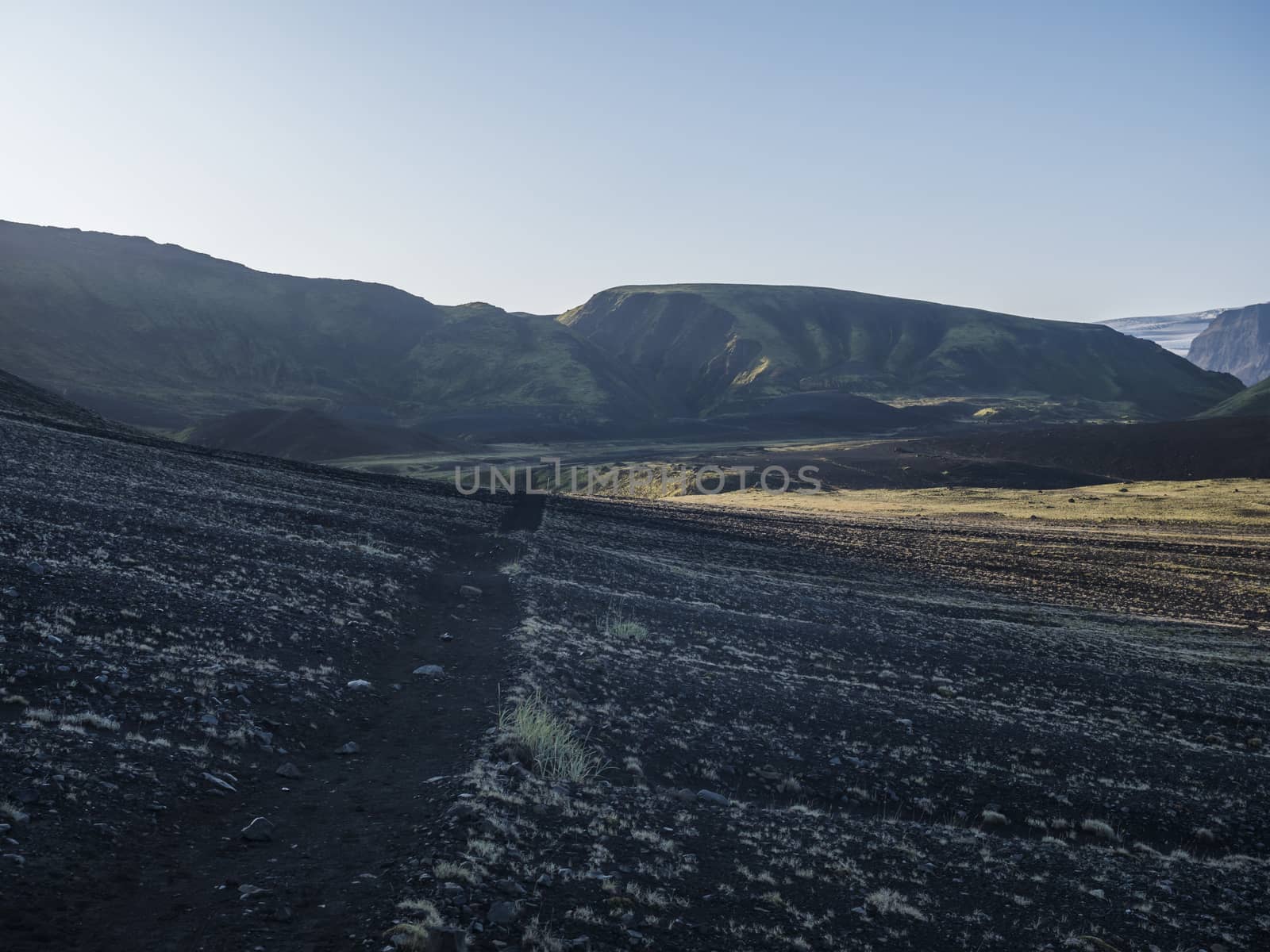 Sunrise view on Myrdalsjokull glacier at Iceland from Laugavegur hiking trail, green valley in volcanic landscape with Early morning pink light.