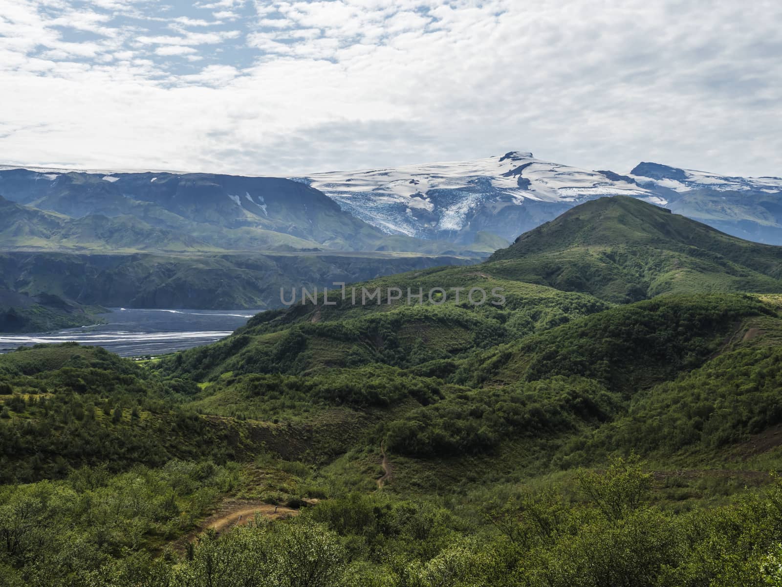 Icelandic landscape with green hills of Thorsmork and eyjafjallajokull volcano glacier. Laugavegur hiking trail. Fjallabak Nature Reserve, Iceland. Summer blue sky.
