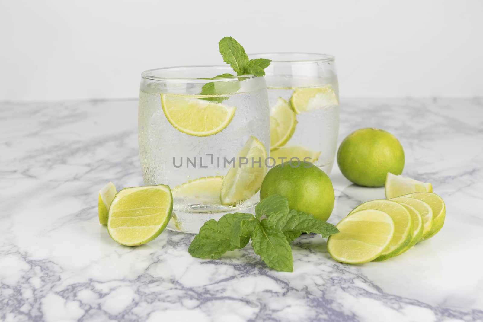 Cold Drink from Lemon cut into pieces in water glass 