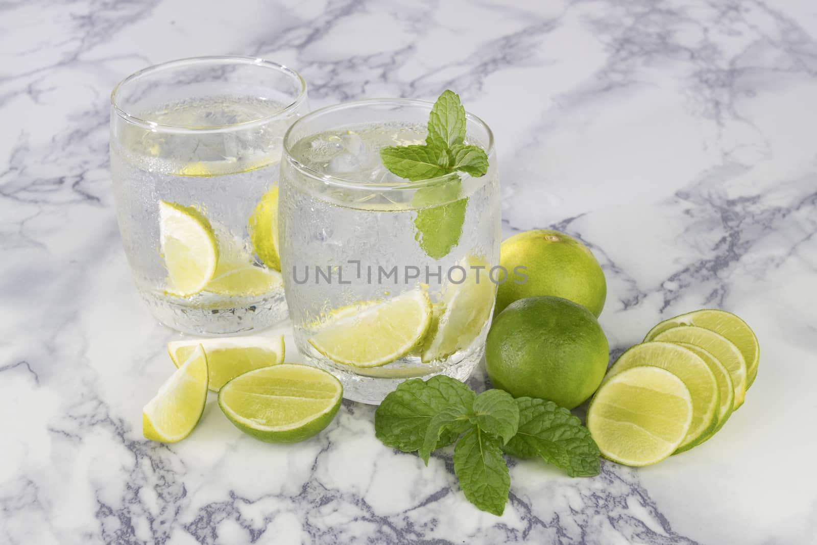 Cold Drink from Lemon cut into pieces in water glass 