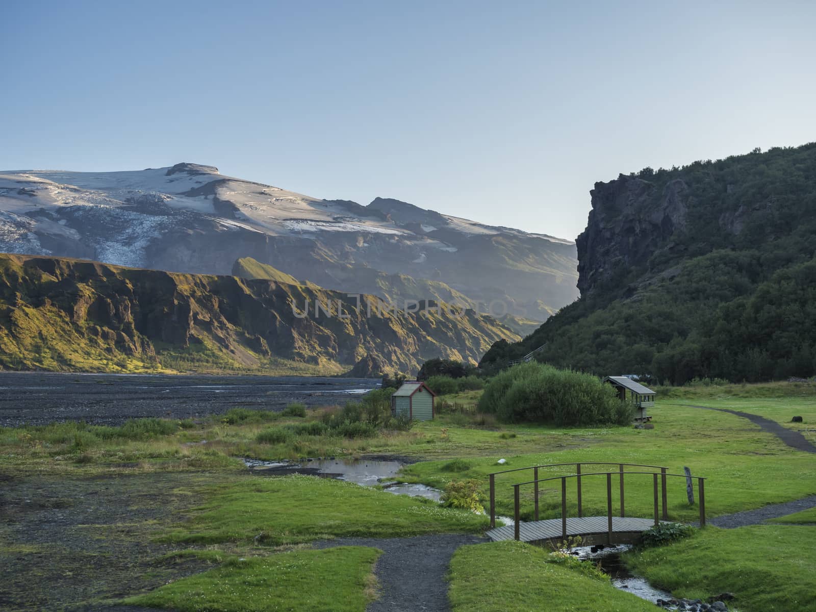 Langidalur camping site in Thorsmork with view on Godaland and Eyjafjallajokull glacier volcano and river Krossa. Highlands of Iceland, end of the Laugavegur hiking trail. Summer Golden hour