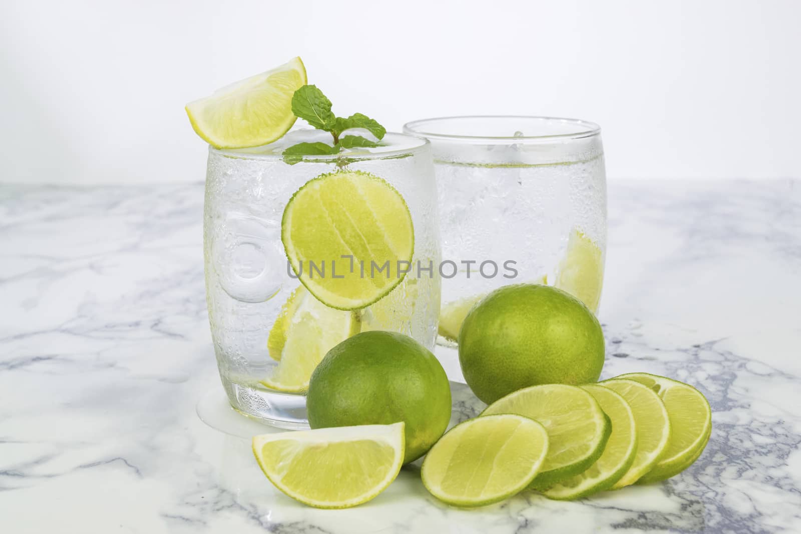 Cold Drink from Lemon cut into pieces in water glass 