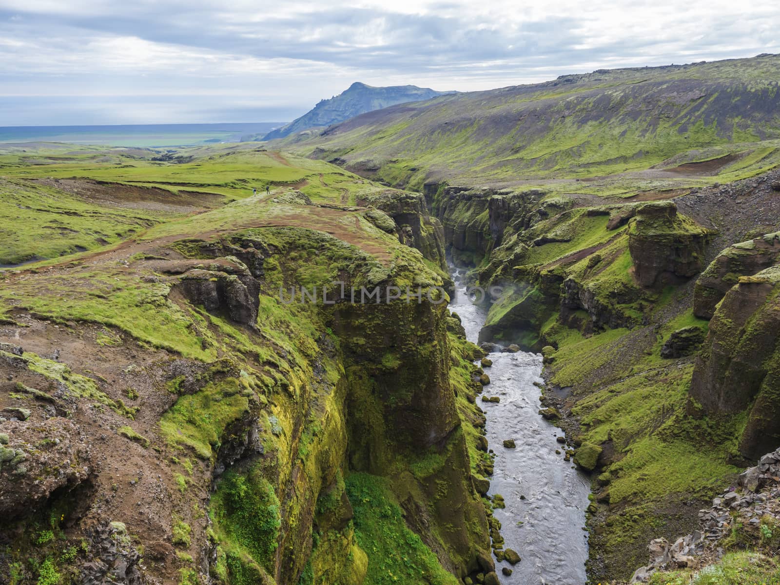 Beautiful lush green Landscape of Skoga river valley cascades near Skogafoss waterfall and Skogar end of Fimmvorduhals hiking trail. South Iceland, Summer blue sky.