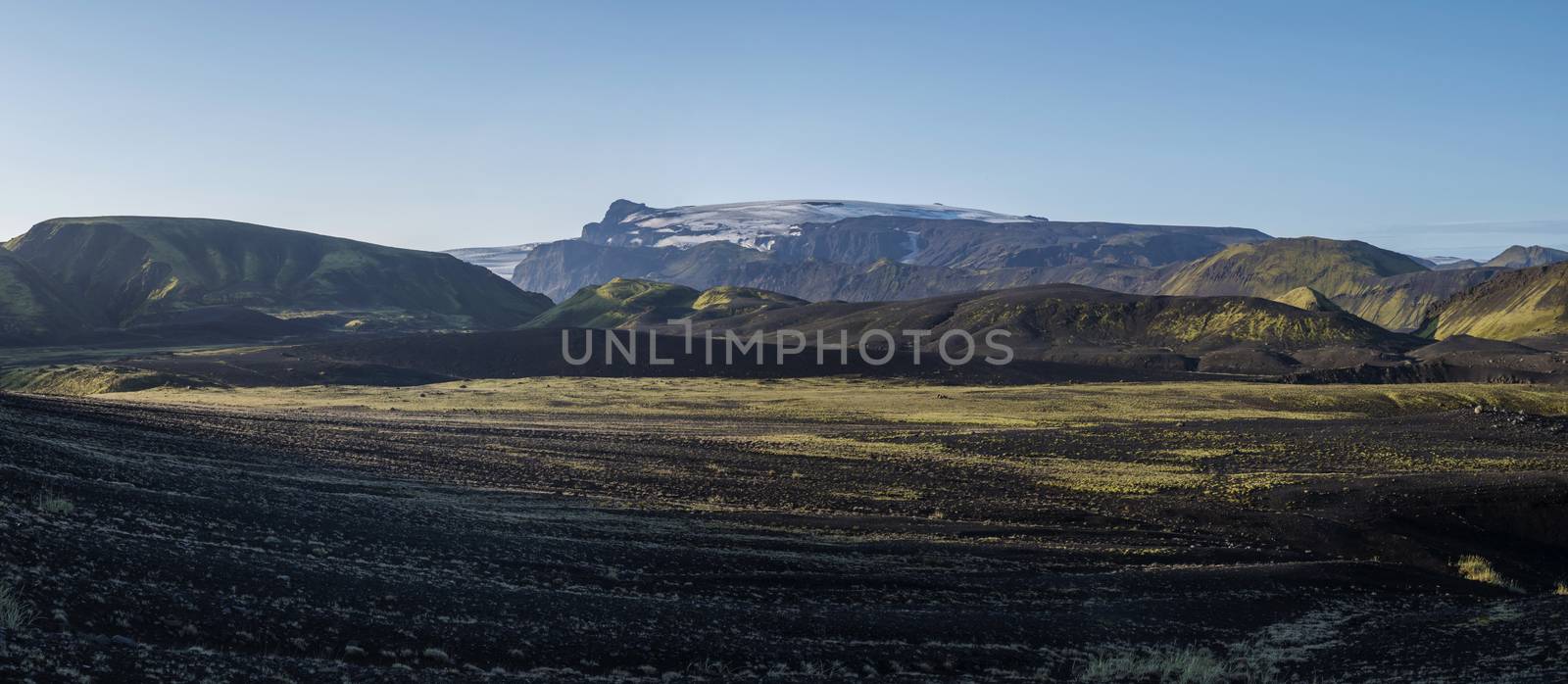 Panoramic sunrise view on Myrdalsjokull glacier. from Botnar campsite at Iceland on Laugavegur hiking trail, green valley in volcanic landscape with Early morning pink light by Henkeova
