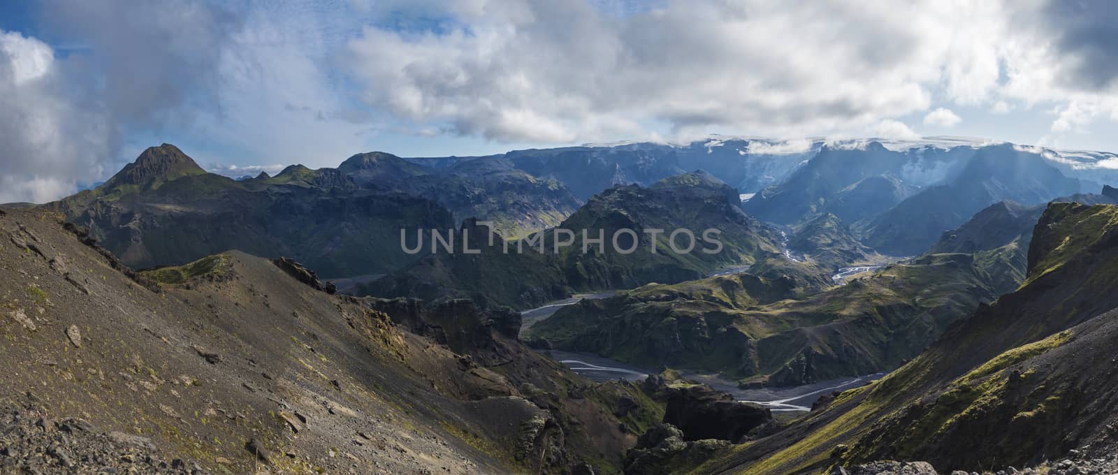 Panoramic breathtaking view on Landscape of Godland and thorsmork with rugged green moss covered rocks and hills, bending river canyon, Iceland, Fimmvorduhals hiking trail. Summer cloudy day