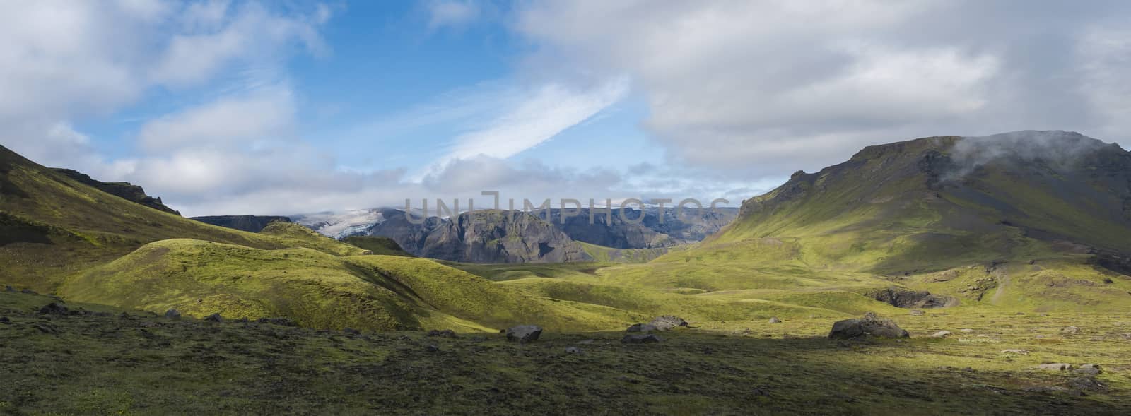 Panoramic breathtaking view on Landscape of Godland and thorsmork with rugged green moss covered hill and Eyjafjallajokull glacier, Iceland, Fimmvorduhals hiking trail. Summer cloudy day. by Henkeova