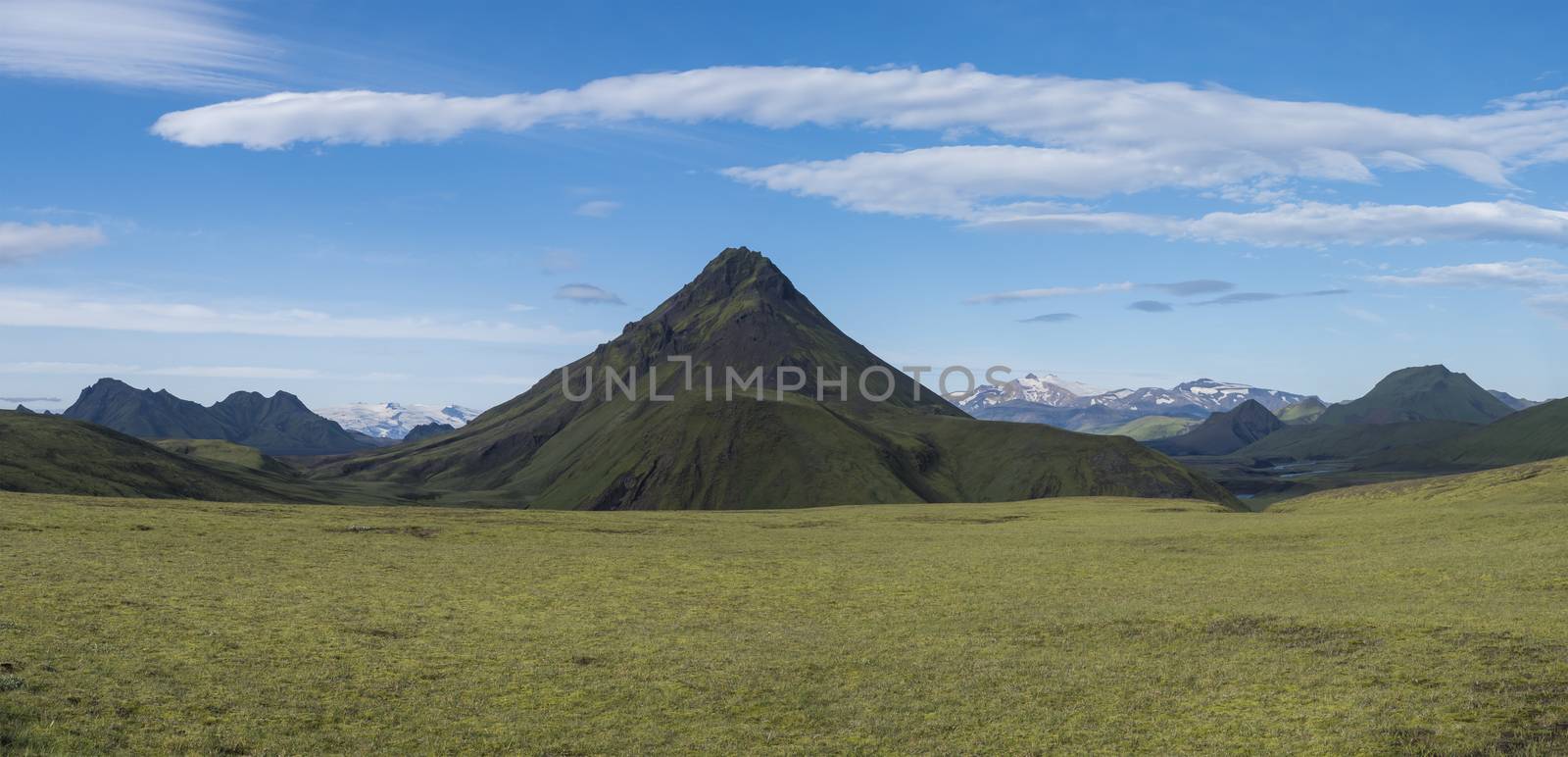 Panoramic volcanic landscape of green Stora-sula mountain with Tindfjallajokull glacier, lush moss and blue creek water on Laugavegur trek in area of Fjallabak Nature Reserve, Iceland by Henkeova
