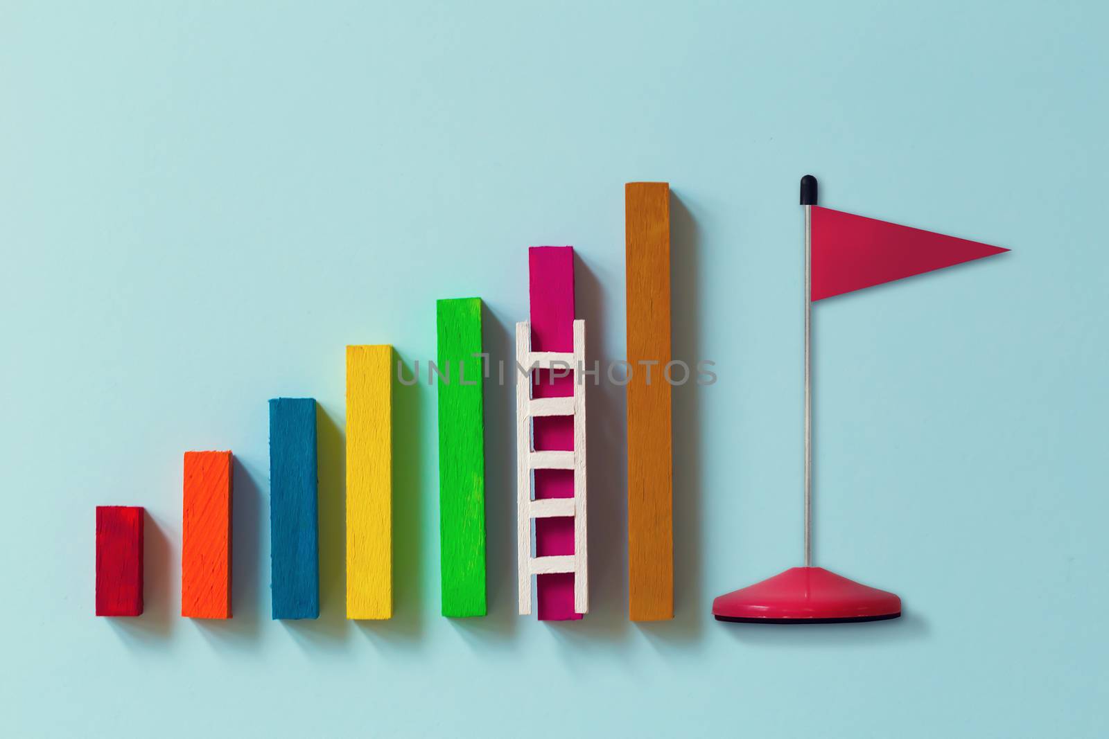 Arrange rising bar graph with stair and red flag. Concept of analysing information / Business concept growth success process: depicts the increment in annual financial budget or revenues of long term