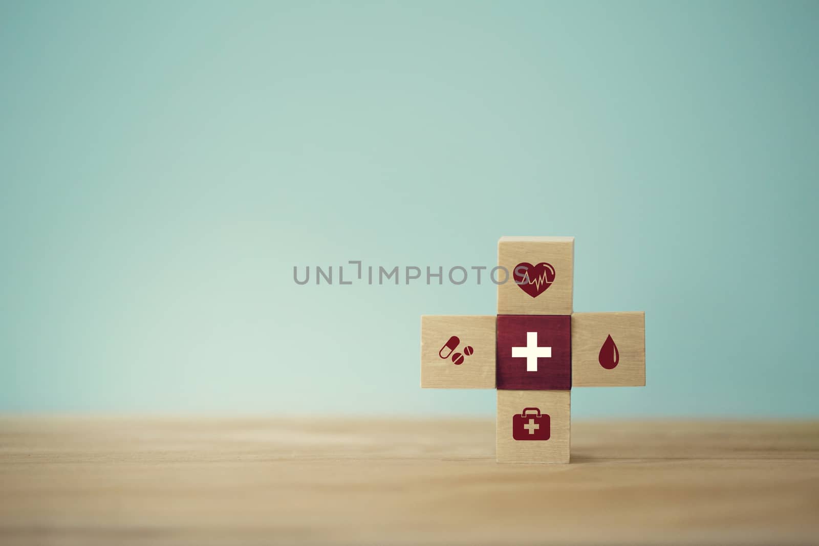 Healthcare concept about of health and medical insurance, arranging wood block stacking with icon healthcare medical on table wooden background. by setila