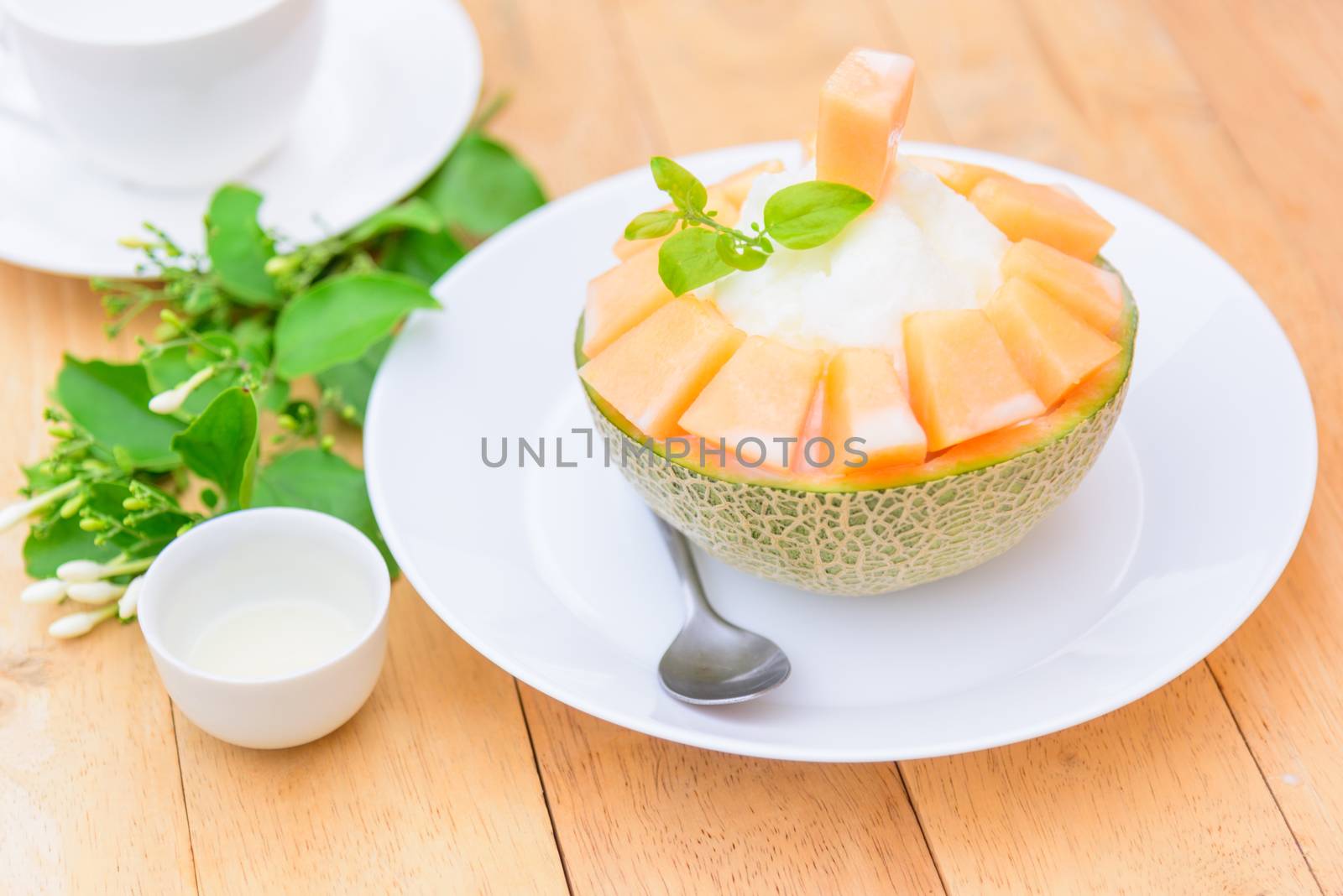 Melon Bingsu with Sweetened Condensed Milk on wood table by rukawajung