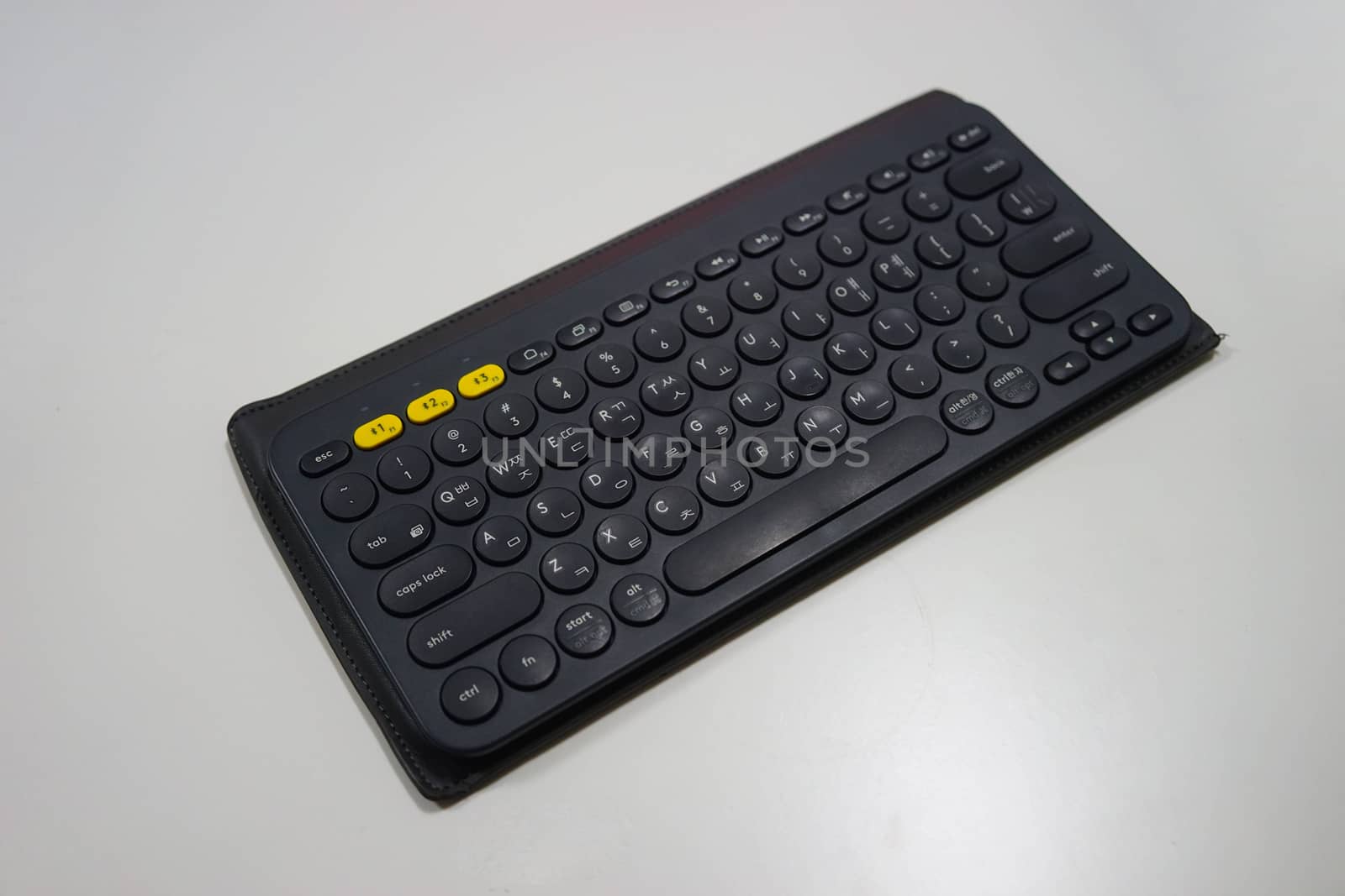Black computer keyboard on white background by uphotopia