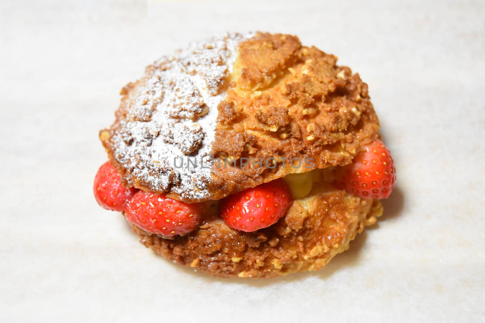 Strawberry cream bread on white background by uphotopia