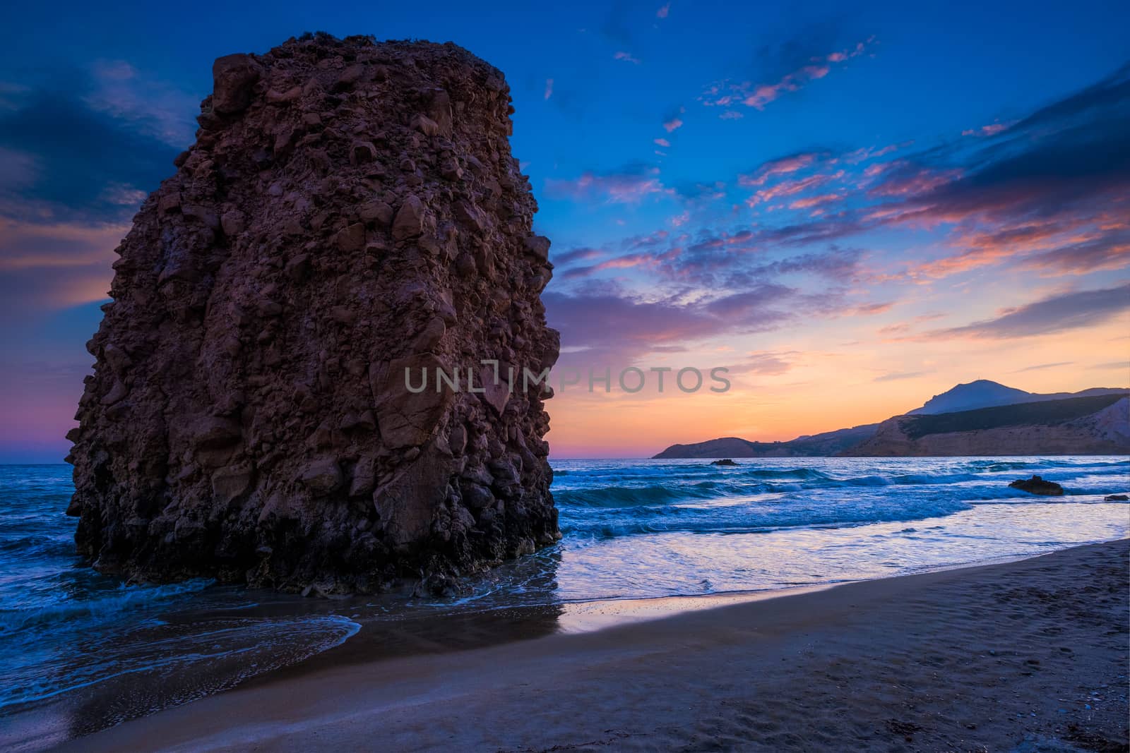 Fyriplaka beach and waves of Aegean sea on sunset, Milos island, Cyclades, Greece