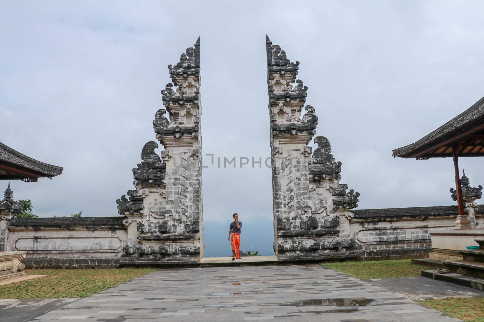 Architecture, traveling and religion. Young traveler enjoying the view in Hindu temple Lempuyang in Bali, Indonesia.