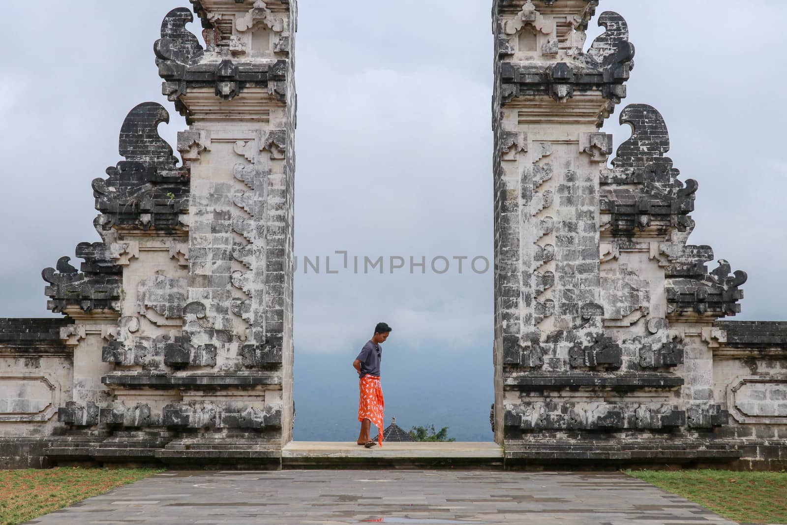Architecture, traveling and religion. Young traveler enjoying the view in Hindu temple Lempuyang in Bali, Indonesia.