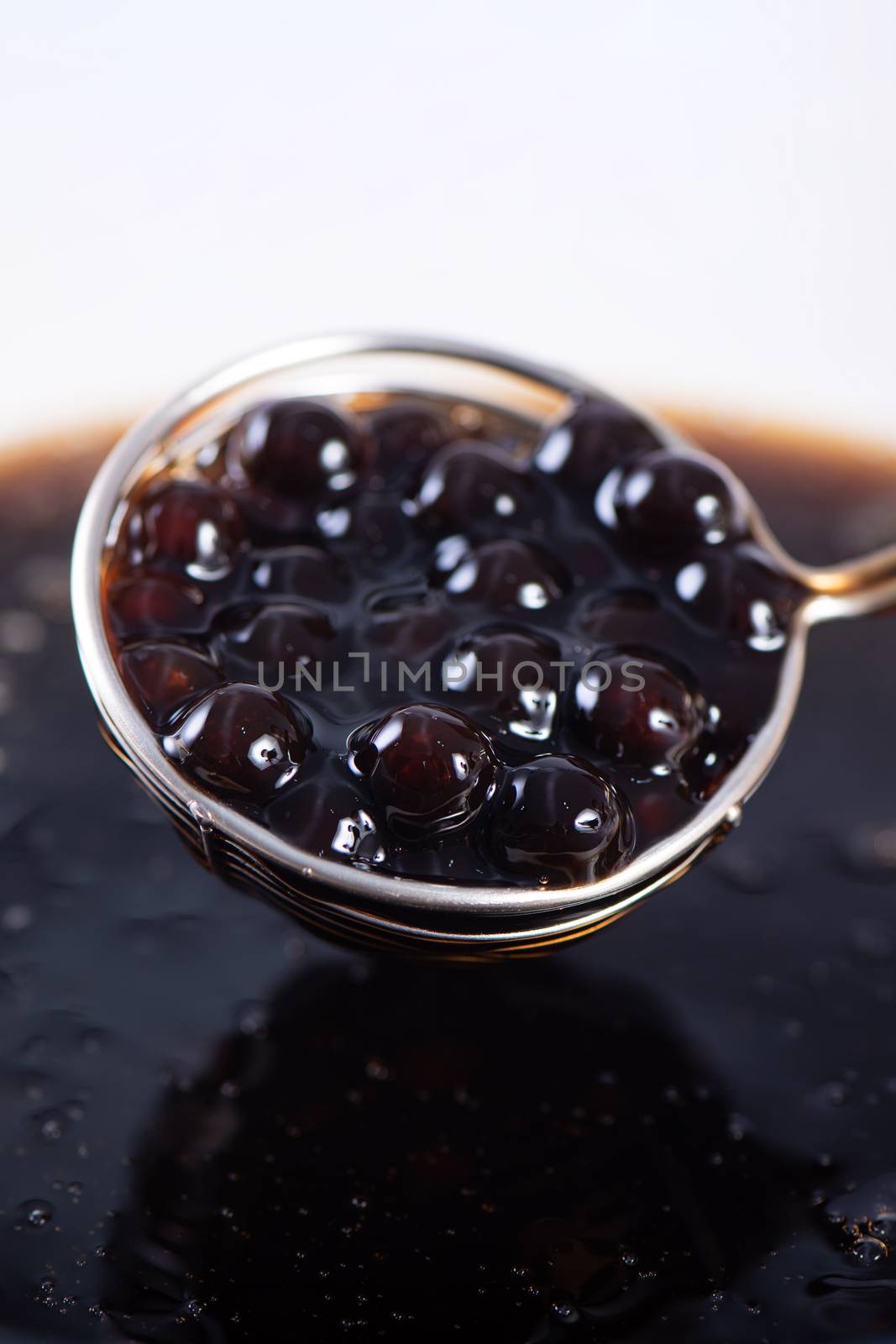 Cooking, boiling brown sugar flavor tapioca pearl balls, ingredient of bubble tea, preparing food and drink, close up, recipe cookbook steps design concept.