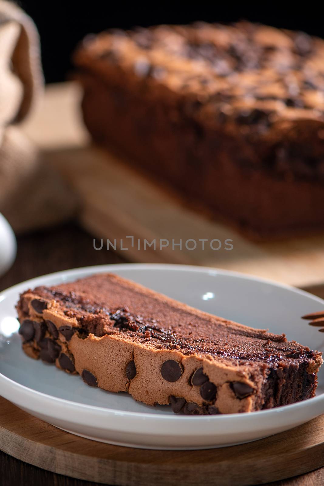 Chocolate flavor Taiwanese traditional sponge cake (Taiwanese castella kasutera) on a wooden tray background table with ingredients, close up.