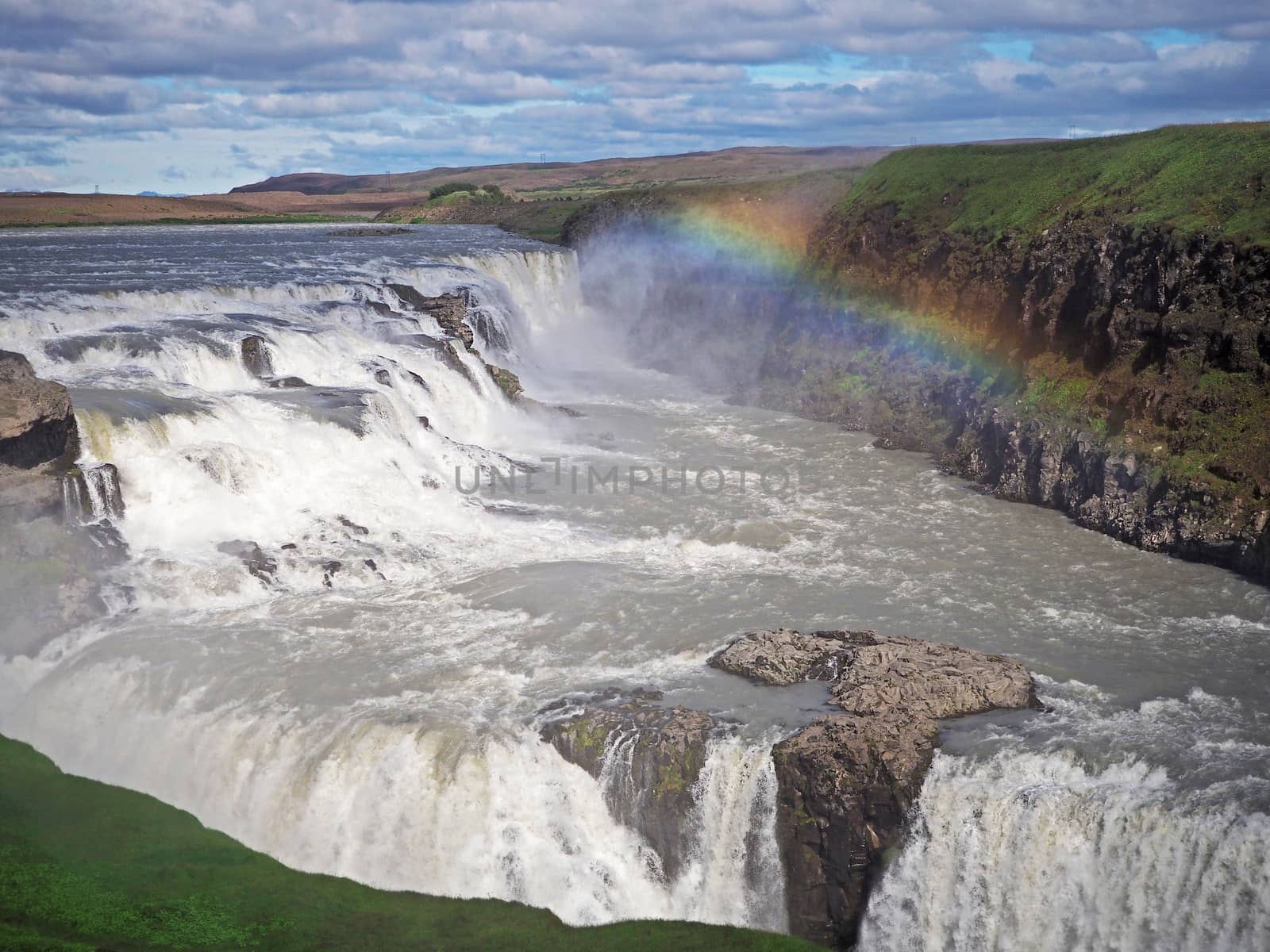 Beautiful Gullfoss waterfall with rainbow overon the Hvita River in southwest Iceland by Henkeova