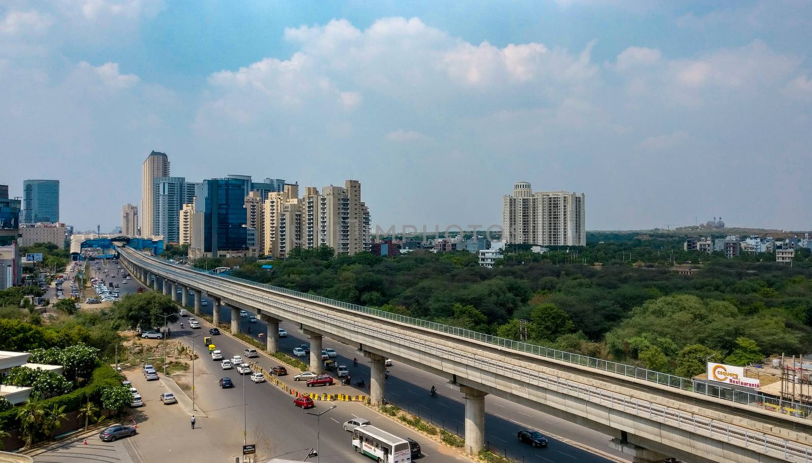 Gurgaon, India, 2020. Aerial shot of Rapid metro tracks in urban areas of Delhi NCR, Gurgaon, Noida with metro running on the tracks. A very useful addition to existing DMRC rail network