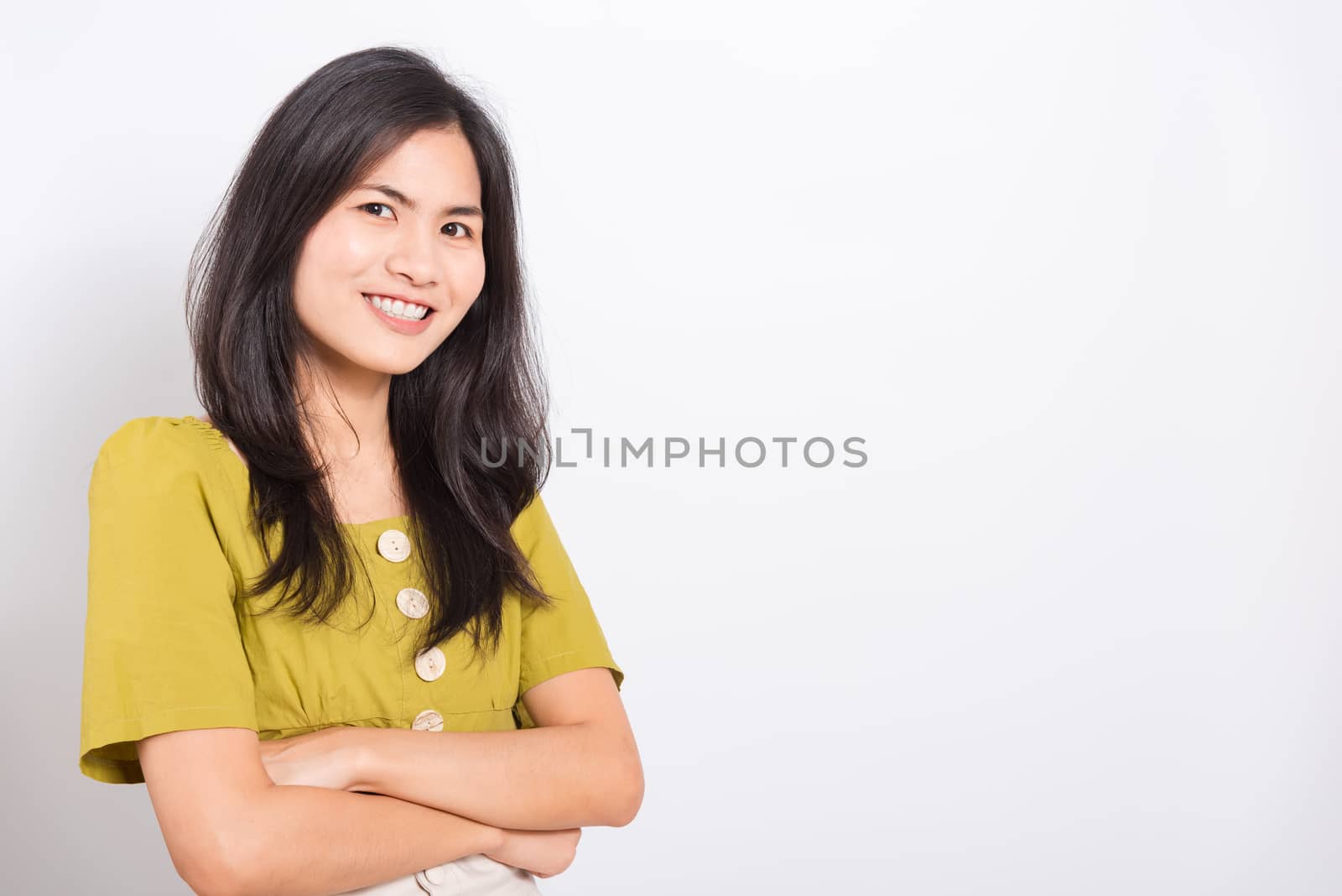 Portrait Asian beautiful young woman standing smile seeing white teeth, She crossed her arms and looking at camera, shoot photo in studio on white background